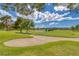 Scenic view of lush green golf course, complete with a sand bunker and serene pond at 4925 Turtle Point Dr, Las Vegas, NV 89113