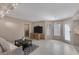 Bright living room with tile floors, TV, and a glass door leading to the outside at 4925 Turtle Point Dr, Las Vegas, NV 89113