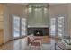 Bright living room featuring a cozy fireplace, neutral walls, and access to outdoor spaces at 4925 Turtle Point Dr, Las Vegas, NV 89113