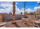 Gravel backyard featuring mature trees, a seating area, and block wall providing privacy at 5125 Hallet Dr, Las Vegas, NV 89122