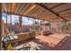 Extended, covered brick patio leads to gravel area with chairs, with bright skies visible beyond the patio at 5125 Hallet Dr, Las Vegas, NV 89122