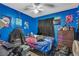 Cozy bedroom features vibrant blue walls and a comfortable space-saving layout at 5125 Hallet Dr, Las Vegas, NV 89122