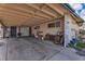 View of a spacious covered carport with storage and a glimpse of the backyard at 5125 Hallet Dr, Las Vegas, NV 89122