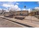 A single-story home with desert landscaping, and a partially fenced yard on a sunny day at 5125 Hallet Dr, Las Vegas, NV 89122