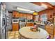 Traditional kitchen with wood cabinets, stainless steel appliances, and a cozy dining area at 5125 Hallet Dr, Las Vegas, NV 89122