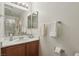 Bathroom vanity with wood cabinets, large mirror, and ample counter space at 513 Rafkin Pl, Henderson, NV 89052