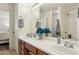 Bright bathroom features double sinks, a large mirror, and a shower/tub combo at 513 Rafkin Pl, Henderson, NV 89052