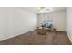 Spacious carpeted bedroom with two chairs, wicker trunk and a bright window at 513 Rafkin Pl, Henderson, NV 89052