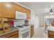 Efficient kitchen with a gas range and adjacent dining area at 513 Rafkin Pl, Henderson, NV 89052