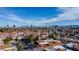 Scenic aerial view of a residential neighborhood showcasing rooftops and the city skyline at 5323 Taravilla Cir, Las Vegas, NV 89146