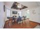 Elegant dining room with wood floors, a modern table, and a mirrored ceiling feature at 5323 Taravilla Cir, Las Vegas, NV 89146