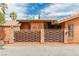 Close-up view of the home's decorative woven fence, terracotta roof, and unique architectural details at 5323 Taravilla Cir, Las Vegas, NV 89146