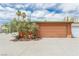 Detached two-car garage with mature landscaping, a well-maintained exterior, and a private driveway at 5323 Taravilla Cir, Las Vegas, NV 89146