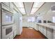 Bright kitchen with white cabinetry, wood floors, and a breakfast bar at 5323 Taravilla Cir, Las Vegas, NV 89146