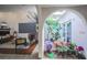 Bright living room featuring a piano, unique floors and a serene atrium filled with plants at 5323 Taravilla Cir, Las Vegas, NV 89146