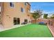 View of the backyard featuring artificial turf, patio, and secure dog run at 5850 Sonoma Station Ave, Las Vegas, NV 89139