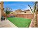 Well maintained backyard with brick perimeter, artificial turf, and dog run at 5850 Sonoma Station Ave, Las Vegas, NV 89139