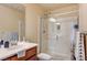 Well-lit bathroom showcases a glass shower, light beige tiling, and modern fixtures at 5850 Sonoma Station Ave, Las Vegas, NV 89139