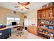 Bedroom featuring a corner desk, a large window, a ceiling fan, and a bookshelf at 5850 Sonoma Station Ave, Las Vegas, NV 89139