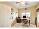 Bedroom with a corner desk, ceiling fan, and a large window overlooking the neighborhood at 5850 Sonoma Station Ave, Las Vegas, NV 89139