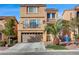 Inviting two-story home boasts desert landscaping, a two-car garage, and an outdoor balcony with a view at 5850 Sonoma Station Ave, Las Vegas, NV 89139