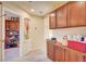 Hallway with built-in cherry cabinets and open access to another room with shelving at 5850 Sonoma Station Ave, Las Vegas, NV 89139