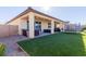 A backyard with a covered patio, artificial grass, and recreational trampoline at 6156 Ava Ridge Ave, Las Vegas, NV 89141