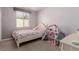 Comfortable bedroom with a pink bed and a dollhouse at 6156 Ava Ridge Ave, Las Vegas, NV 89141