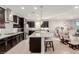 Modern kitchen featuring dark cabinets, stainless steel appliances, and a large center island at 6156 Ava Ridge Ave, Las Vegas, NV 89141