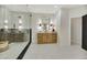 Bright bathroom featuring double vanities, a glass shower, and stylish light fixtures at 62 Incline Village Ct, Henderson, NV 89074