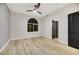 Bedroom featuring wood-look flooring, an arched window, ceiling fan, and neutral paint at 62 Incline Village Ct, Henderson, NV 89074