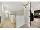 Bright hallway with wood-look floors, modern lighting, and white walls at 62 Incline Village Ct, Henderson, NV 89074