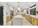 Modern kitchen featuring a large island, stainless steel refrigerator, and light wood flooring at 62 Incline Village Ct, Henderson, NV 89074