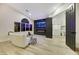 Stylish living room with linear fireplace, large-screen TV, and an open doorway to the kitchen at 62 Incline Village Ct, Henderson, NV 89074