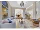 Sunken living room showcasing stairs to dining area, large window, and staircase at 62 Incline Village Ct, Henderson, NV 89074