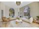 Living room featuring neutral colors, modern furniture, and natural light from arched windows at 62 Incline Village Ct, Henderson, NV 89074