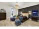 Modern main bedroom with dark accent wall, stylish chandelier, and cozy blue chairs at 62 Incline Village Ct, Henderson, NV 89074