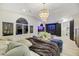 Bright main bedroom featuring a fireplace, a large bed, and a modern chandelier at 62 Incline Village Ct, Henderson, NV 89074