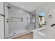 Bright bathroom featuring a tiled shower with bench and modern fixtures, and a door to the pool area at 6664 Rutgers Dr, Las Vegas, NV 89156