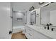 Bathroom featuring double sinks, gray tiled shower and modern fixtures at 6664 Rutgers Dr, Las Vegas, NV 89156