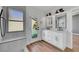 Bright bathroom with double vanity, stone counter, and a glass door to the outside at 6664 Rutgers Dr, Las Vegas, NV 89156