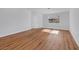 Inviting bedroom with wood-look floors, natural light from the windows, and a white door at 6664 Rutgers Dr, Las Vegas, NV 89156