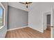 Bedroom featuring gray accent wall, wood-look laminate floors, fan and a closet at 6664 Rutgers Dr, Las Vegas, NV 89156