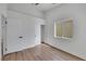 A simple bedroom featuring wood-look flooring, closet and doorway access and a window at 6664 Rutgers Dr, Las Vegas, NV 89156