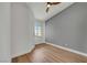 Bedroom featuring gray accent wall, wood-look laminate floors, fan and a window at 6664 Rutgers Dr, Las Vegas, NV 89156