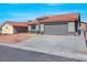 The exterior of this home features a tile roof and a two-car garage at 6664 Rutgers Dr, Las Vegas, NV 89156