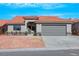 Charming house with a tile roof, well-maintained landscaping, and a two-car garage at 6664 Rutgers Dr, Las Vegas, NV 89156