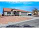 Single story home with desert landscaping, spacious driveway, two car garage and red tile roof at 6664 Rutgers Dr, Las Vegas, NV 89156