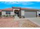 Attractive single-story home featuring a red tile roof, a two-car garage, and desert landscaping at 6664 Rutgers Dr, Las Vegas, NV 89156