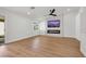 Modern living room showcasing an electric fireplace, large screen TV, and wood-look flooring at 6664 Rutgers Dr, Las Vegas, NV 89156